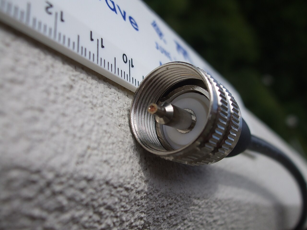 A UHF series PL-259 coaxial plug showing the threaded shell and center pin